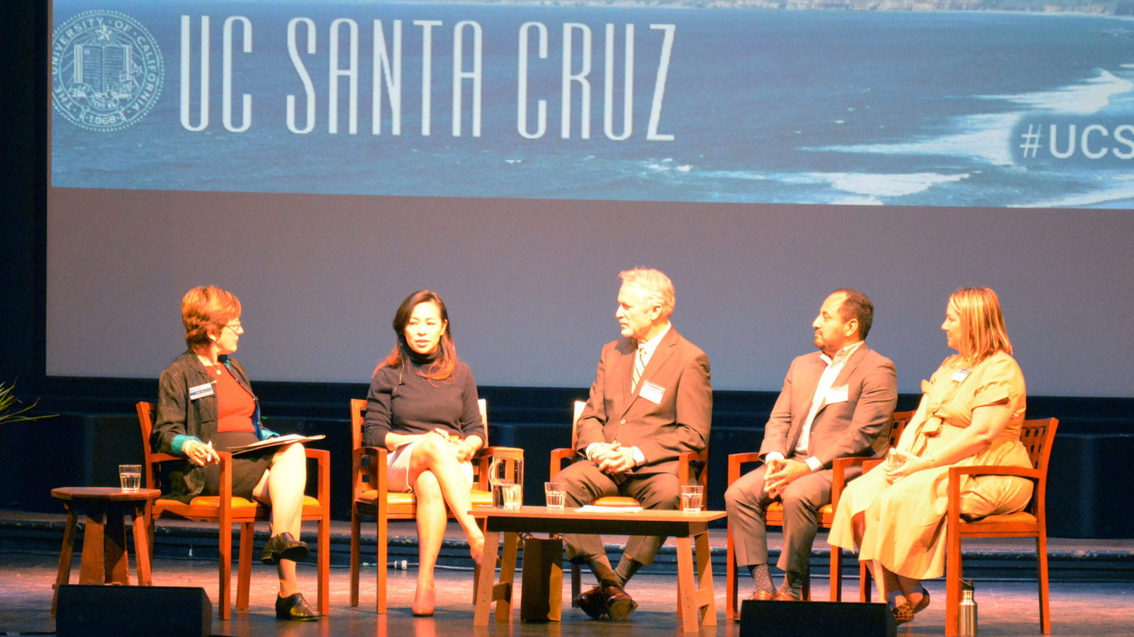 5 people talking on a stage at uc Santa Cruz